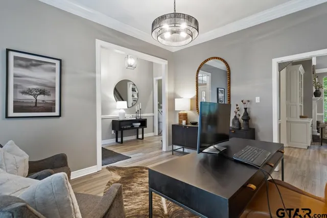 a bedroom with a bed and a chandelier