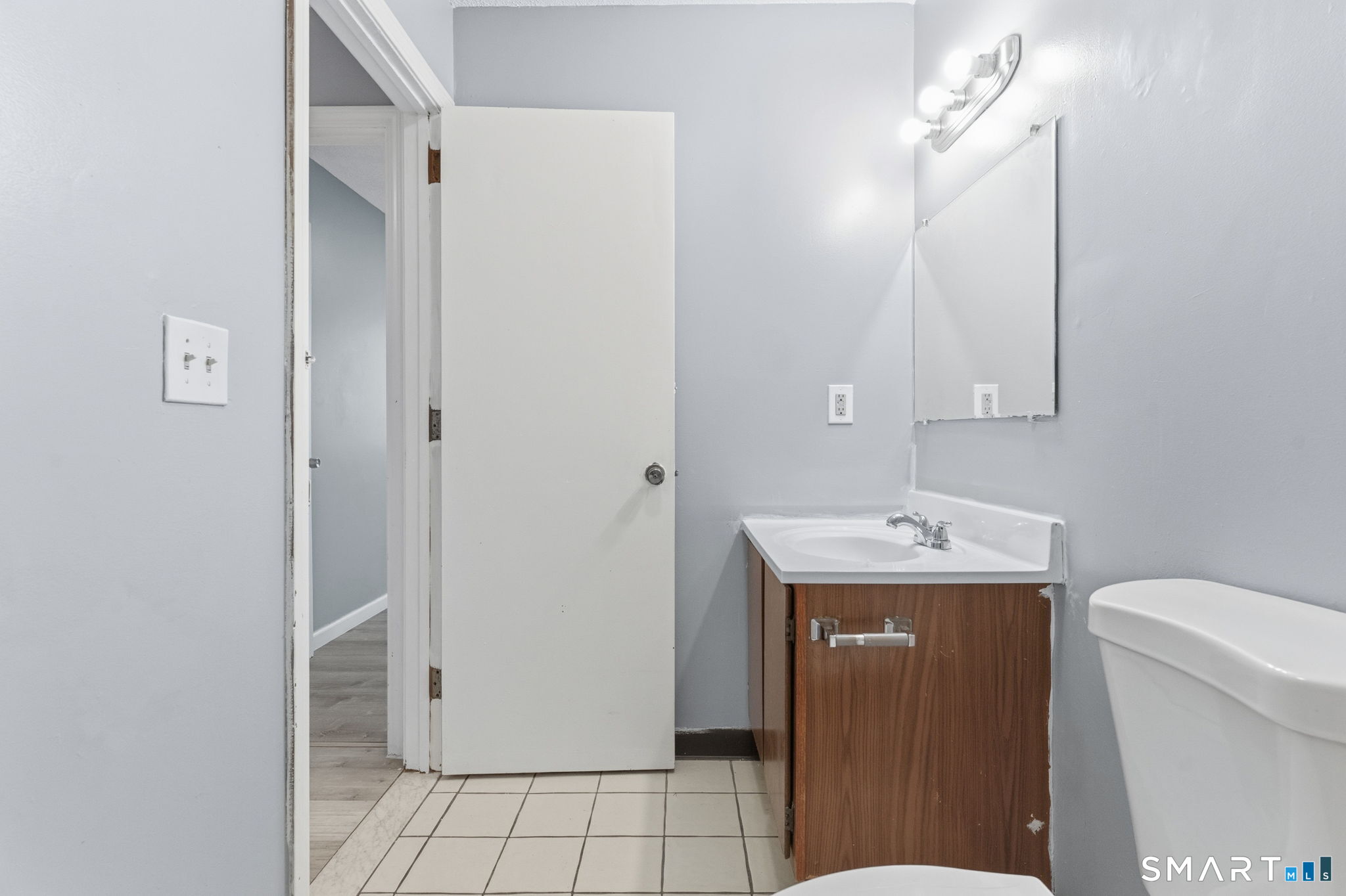 5-7 Warner St Extension, Unit 5B Hartford, CT 06114 - Photo 12 of 17 a bathroom with a sink a toilet and mirror