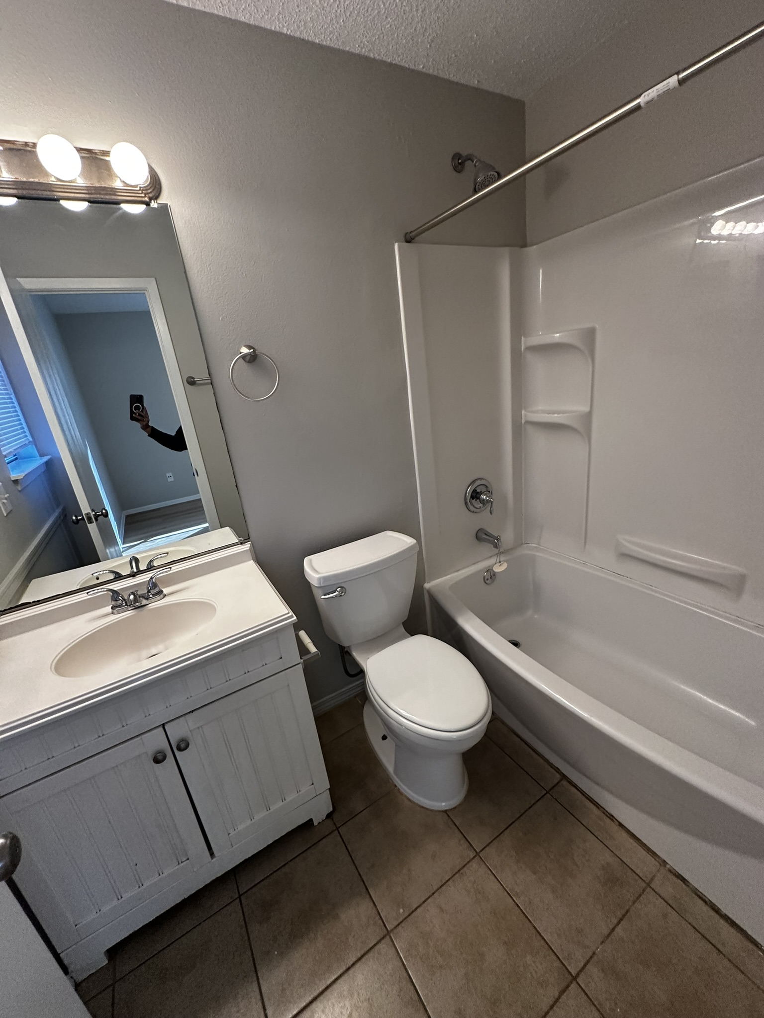 2606 Howellwood Way, Unit A Austin, TX 78748 - Photo 14 of 15 Full bathroom with shower / tub combination, a textured ceiling, vanity, and light tile patterned floors