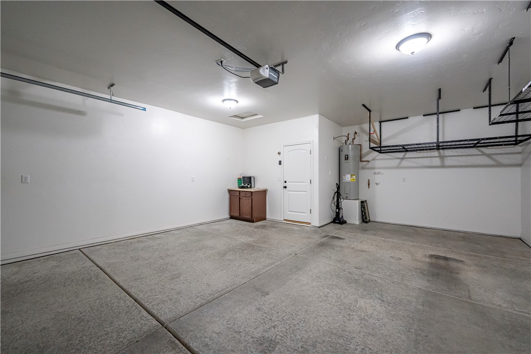 3546 North Kenneth Road Kingman, AZ 86409 - Photo 25 of 35 The property features a garage with concrete flooring, overhead lighting, and white walls