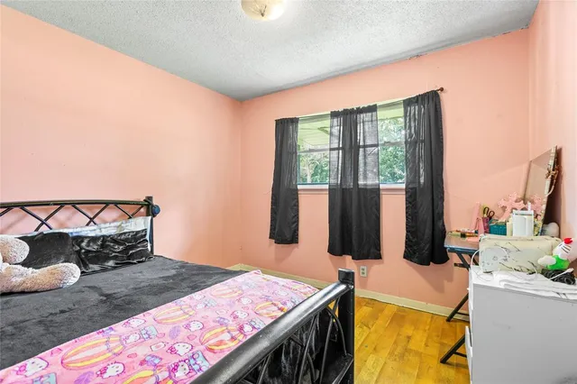 a bed sitting in a bedroom next to a window