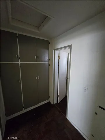 an empty room with wooden floor and closet