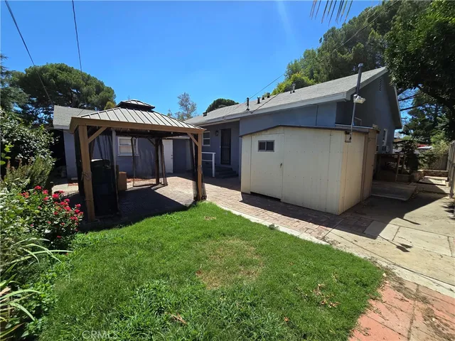 a view of a backyard with plants and a tub