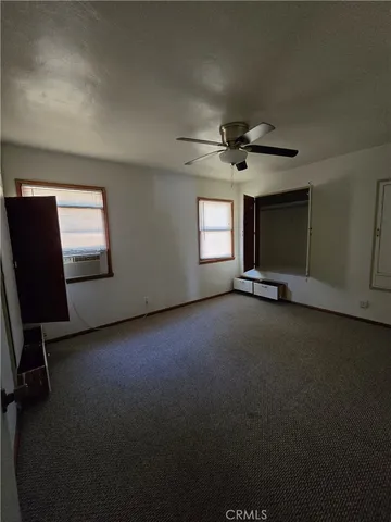 a view of a livingroom with a ceiling fan and window