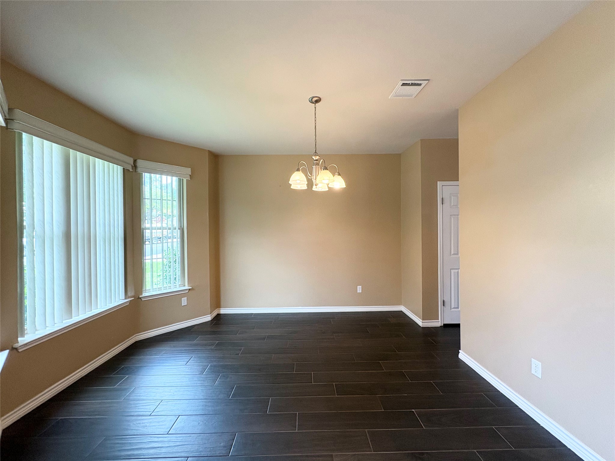 8103 Ephraim Road Austin, TX 78717 - Photo 5 of 35 Natural illumination fills this room, showcasing rich dark wood flooring.