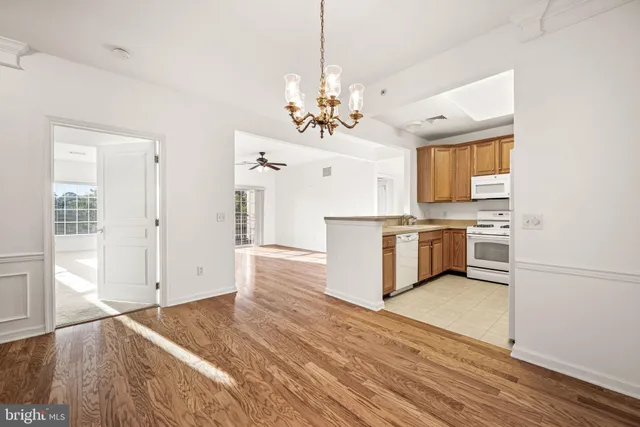 a view of a room with wooden floor and white walls