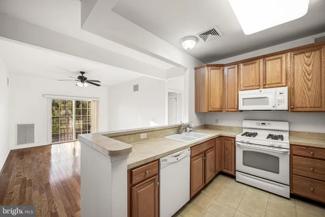 a view of a kitchen with a sink cabinets and wooden floor