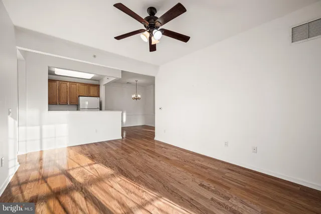 a view of a kitchen with a sink and dishwasher cabinet with wooden floor