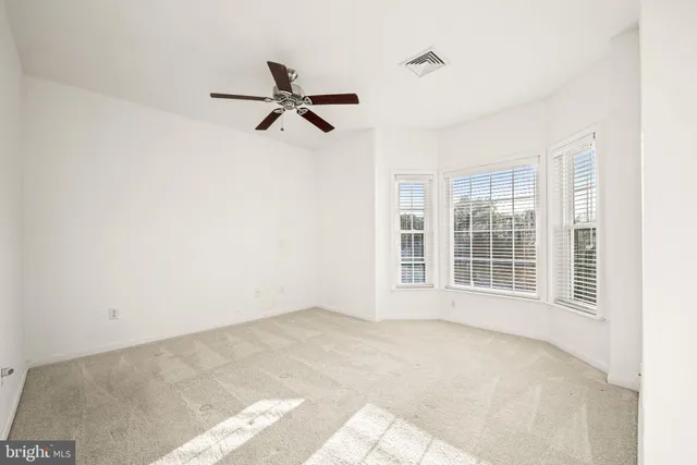 a view of a kitchen with wooden floor and a ceiling fan