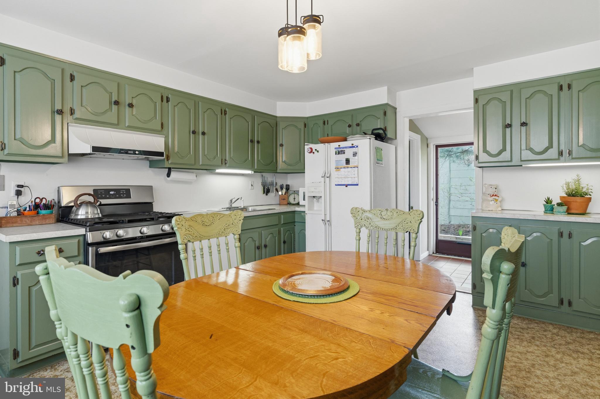 1268 Ashbourne Road Elkins Park, PA 19027 - Photo 14 of 46 a kitchen with stainless steel appliances granite countertop a dining table and chairs