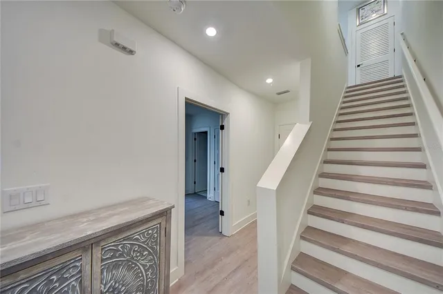 a bathroom with a double vanity sink a toilet and shower