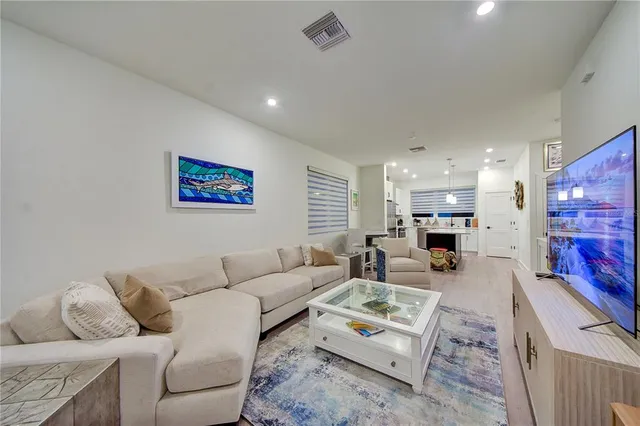a living room with furniture flat screen tv and a fireplace