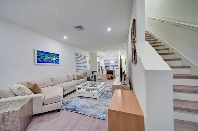 a kitchen with stainless steel appliances granite countertop a refrigerator a sink and a stove