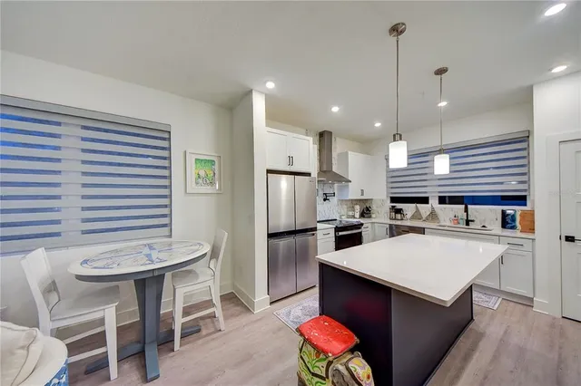 a kitchen with stainless steel appliances granite countertop a refrigerator and a sink