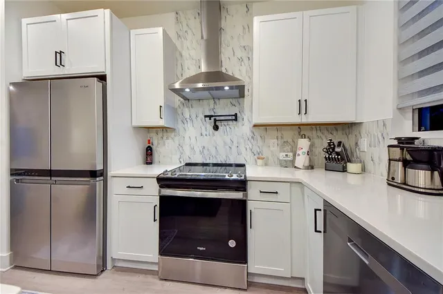 a view of a hallway with bathroom and wooden floor