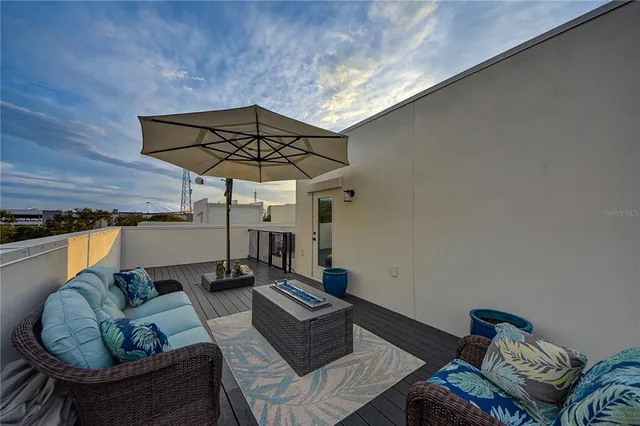 a view of roof deck with sunset view