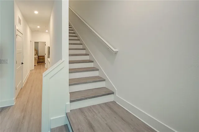 a view of a white house with a yard and garage