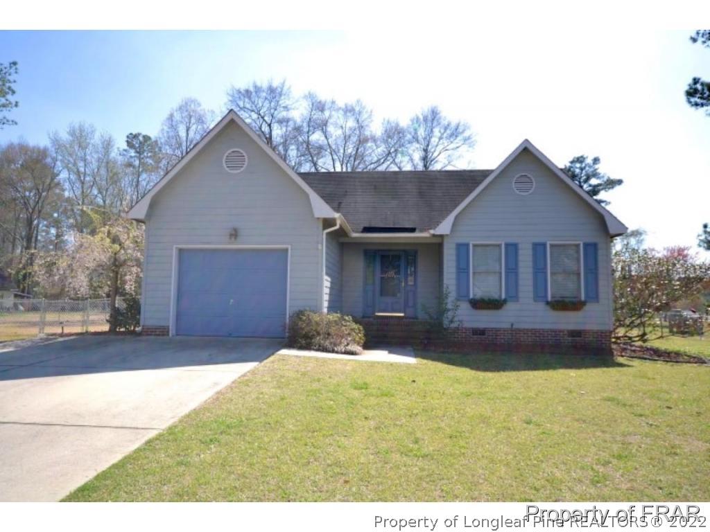 511 Berwick Drive Raeford, NC 28376 - Photo 1 of 26 a front view of a house with a yard and garage
