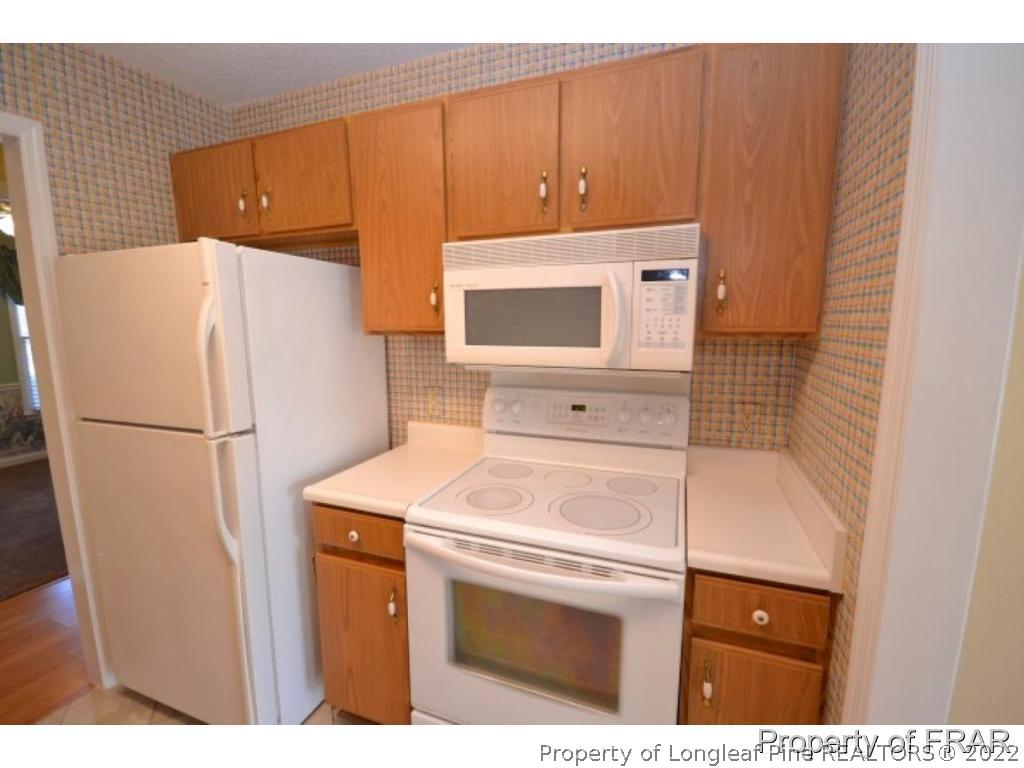 511 Berwick Drive Raeford, NC 28376 - Photo 11 of 26 a white refrigerator freezer sitting inside of a kitchen