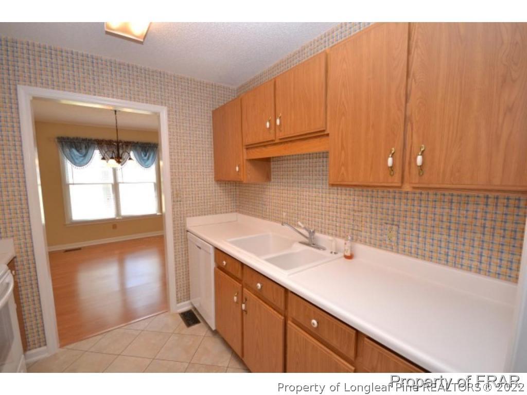 511 Berwick Drive Raeford, NC 28376 - Photo 12 of 26 a kitchen with a sink cabinets and a window