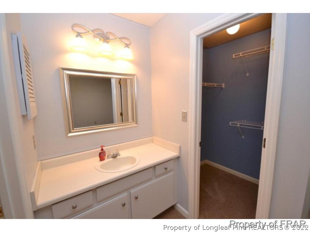 511 Berwick Drive Raeford, NC 28376 - Photo 17 of 26 a bathroom with a sink vanity and a mirror