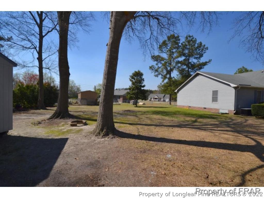 511 Berwick Drive Raeford, NC 28376 - Photo 25 of 26 a view of a yard with wooden fence