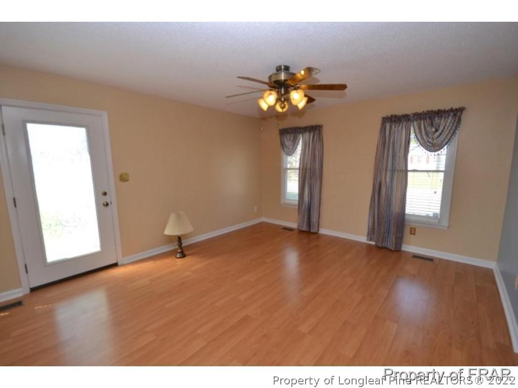 511 Berwick Drive Raeford, NC 28376 - Photo 3 of 26 a view of an empty room with a window and wooden floor