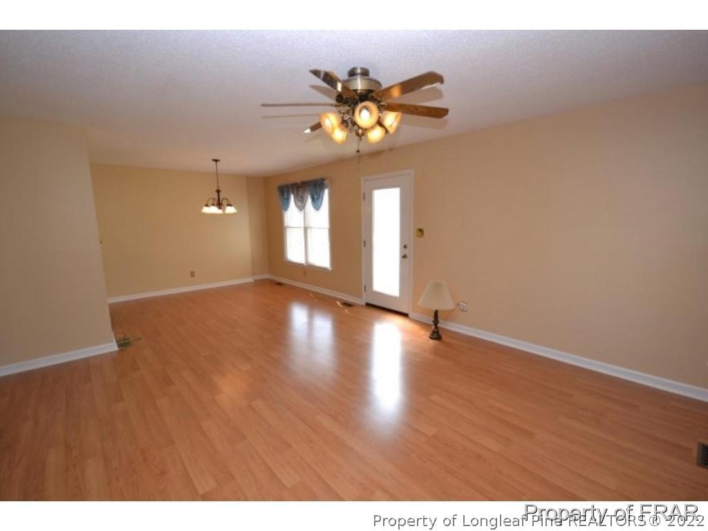 511 Berwick Drive Raeford, NC 28376 - Photo 4 of 26 a view of an empty room with window and wooden floor