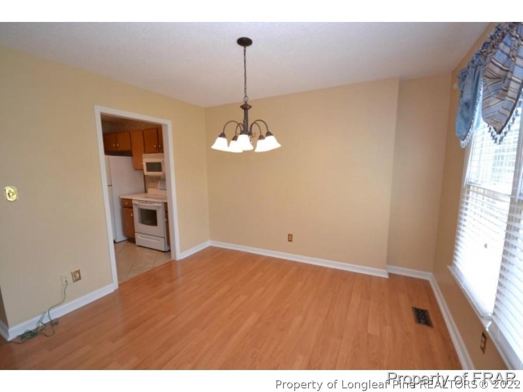 511 Berwick Drive Raeford, NC 28376 - Photo 7 of 26 a view of a room with a window and wooden floor