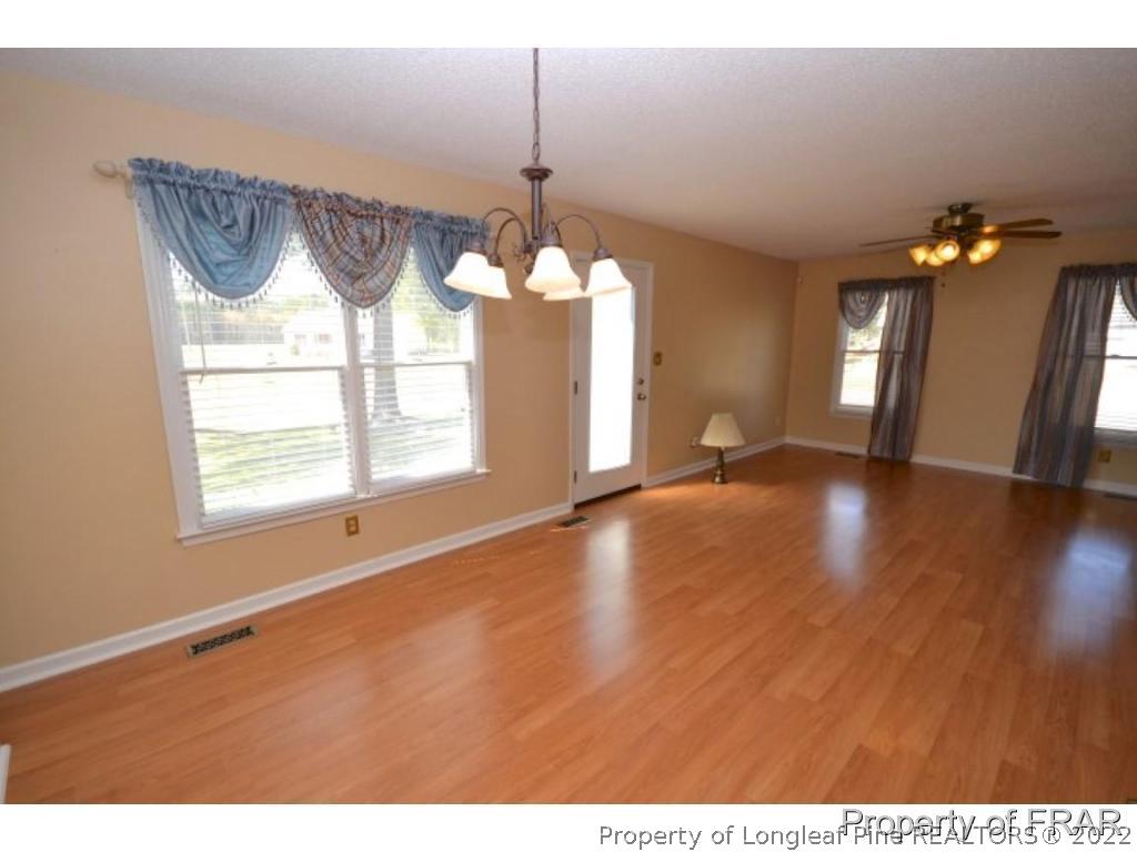 511 Berwick Drive Raeford, NC 28376 - Photo 8 of 26 a view of an empty room with wooden floor and a window