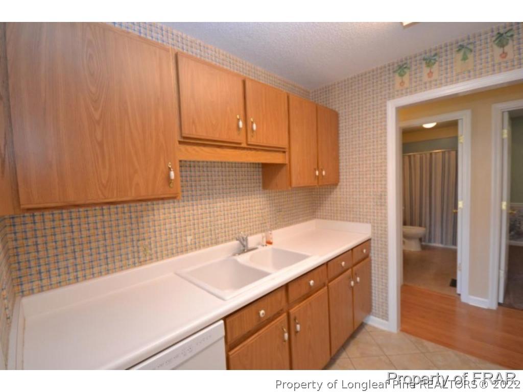511 Berwick Drive Raeford, NC 28376 - Photo 10 of 26 a kitchen with a sink cabinets and a wooden floor