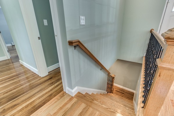 234 Ridge Street Winchester, MA 01890 - Photo 15 of 26 a view of a hallway with wooden floor and staircase