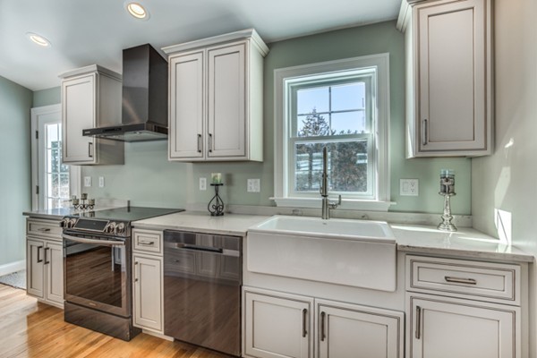 234 Ridge Street Winchester, MA 01890 - Photo 7 of 26 a kitchen with stainless steel appliances granite countertop a sink stove and cabinets