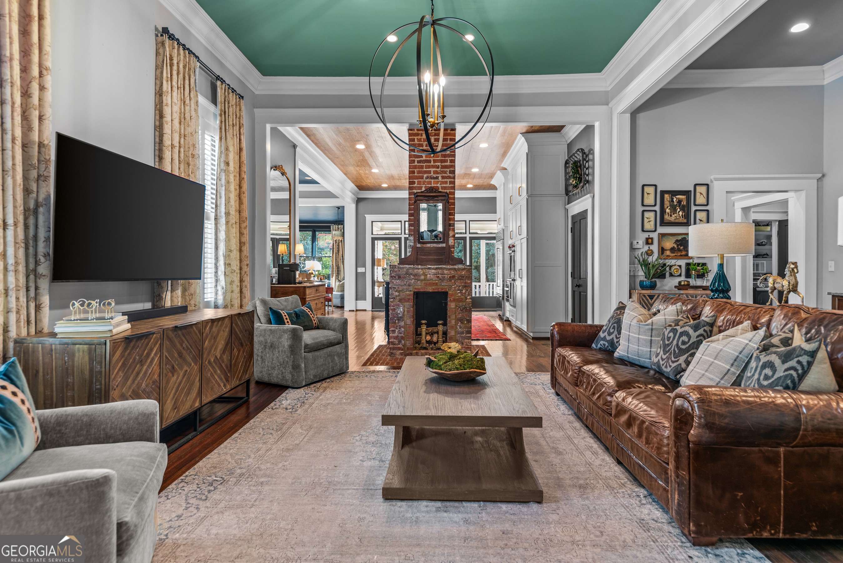 668 North Main Street Madison, GA 30650 - Photo 12 of 88 a living room with furniture a flat screen tv and a fireplace