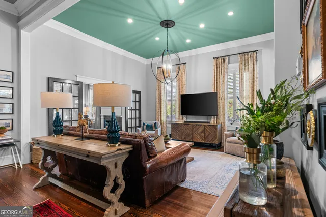 a living room with furniture and a chandelier