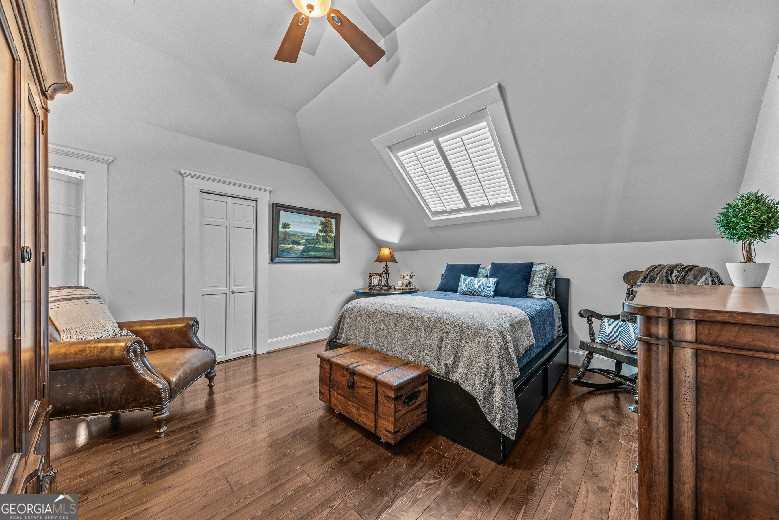 668 North Main Street Madison, GA 30650 - Photo 45 of 88 a spacious bedroom with a bed a table and chair