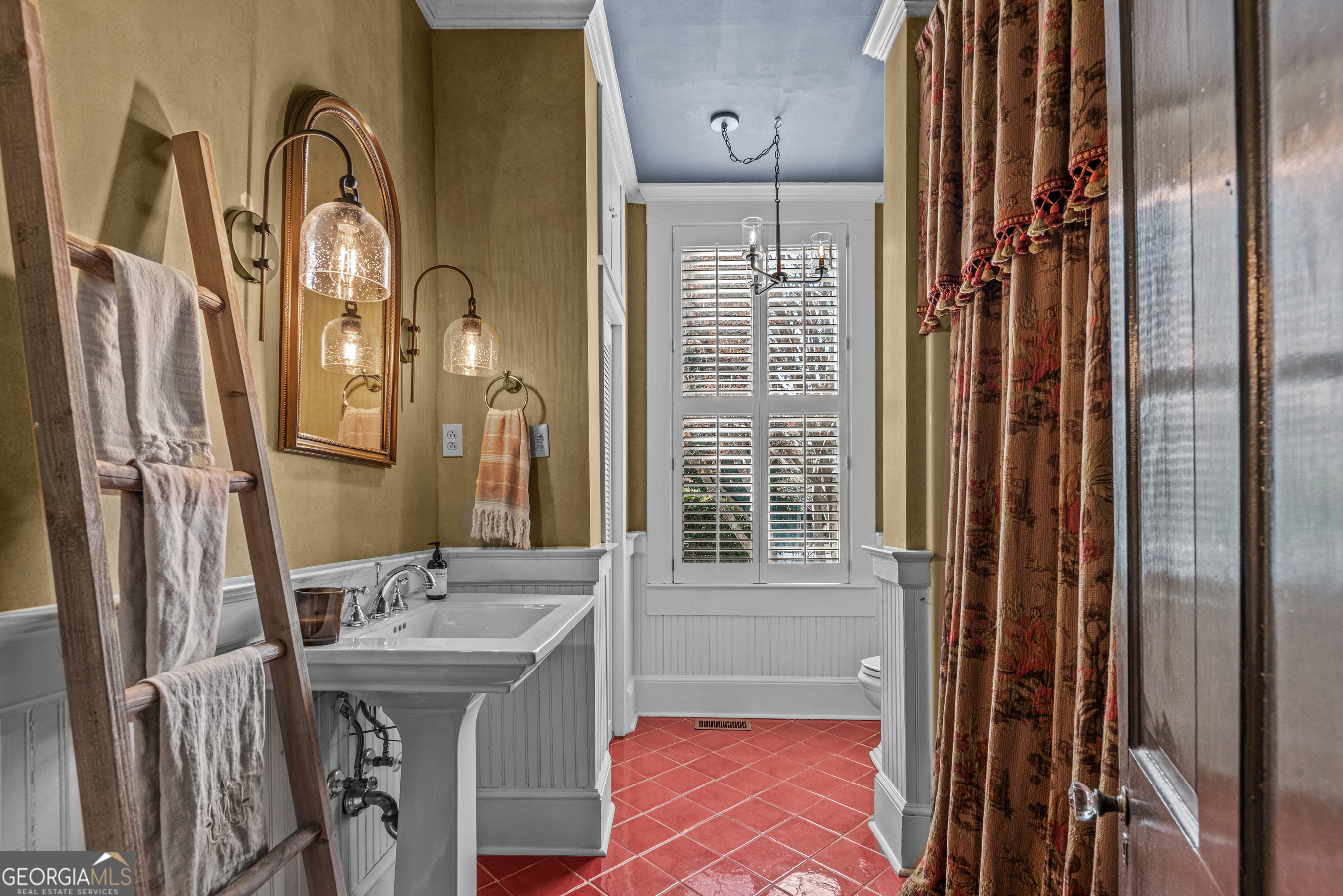 668 North Main Street Madison, GA 30650 - Photo 47 of 88 a bathroom with a sink a mirror and a shower