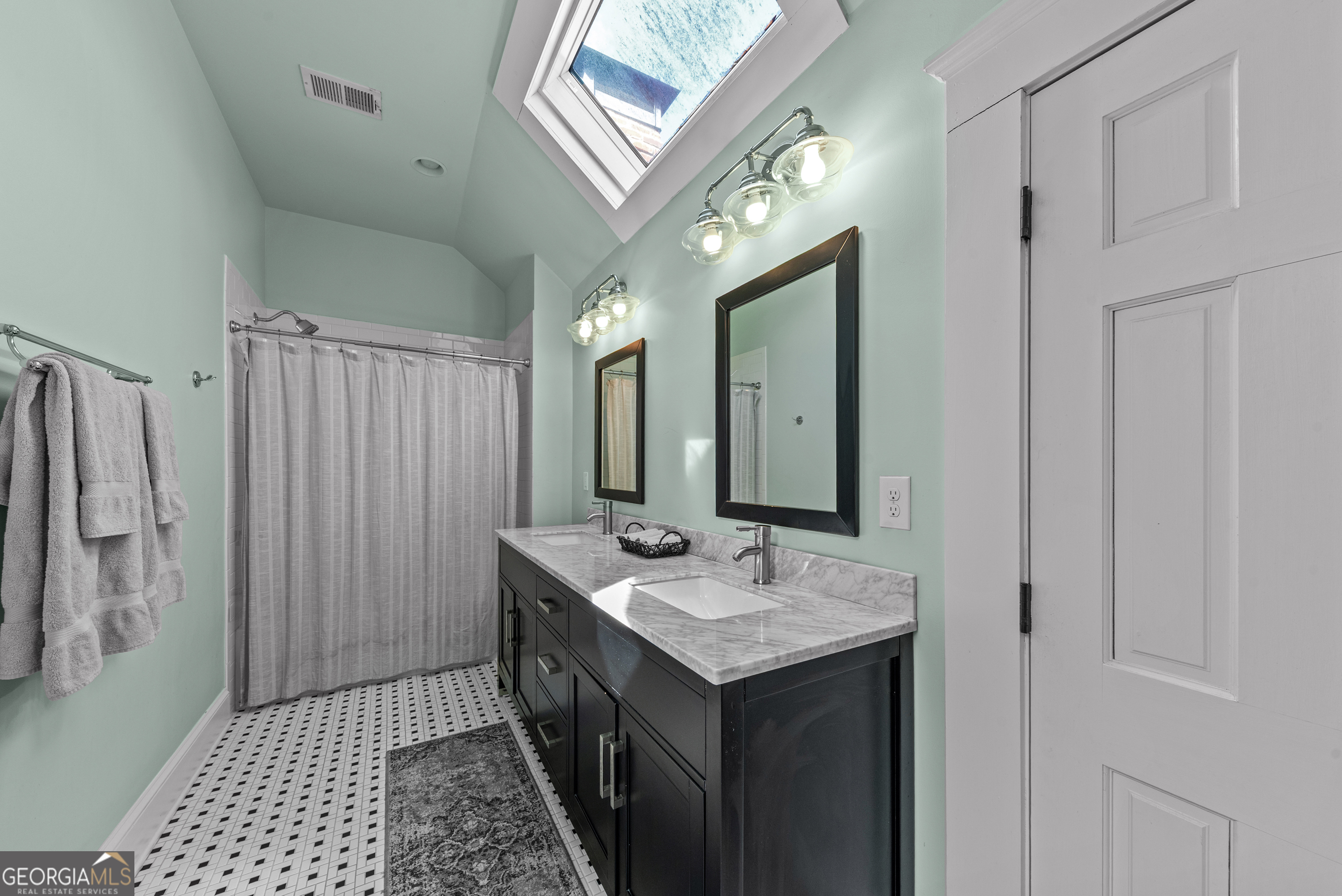 668 North Main Street Madison, GA 30650 - Photo 53 of 88 a bathroom with a sink a mirror and a shower