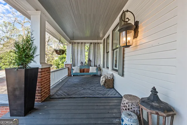 a living room with furniture chandelier and a rug