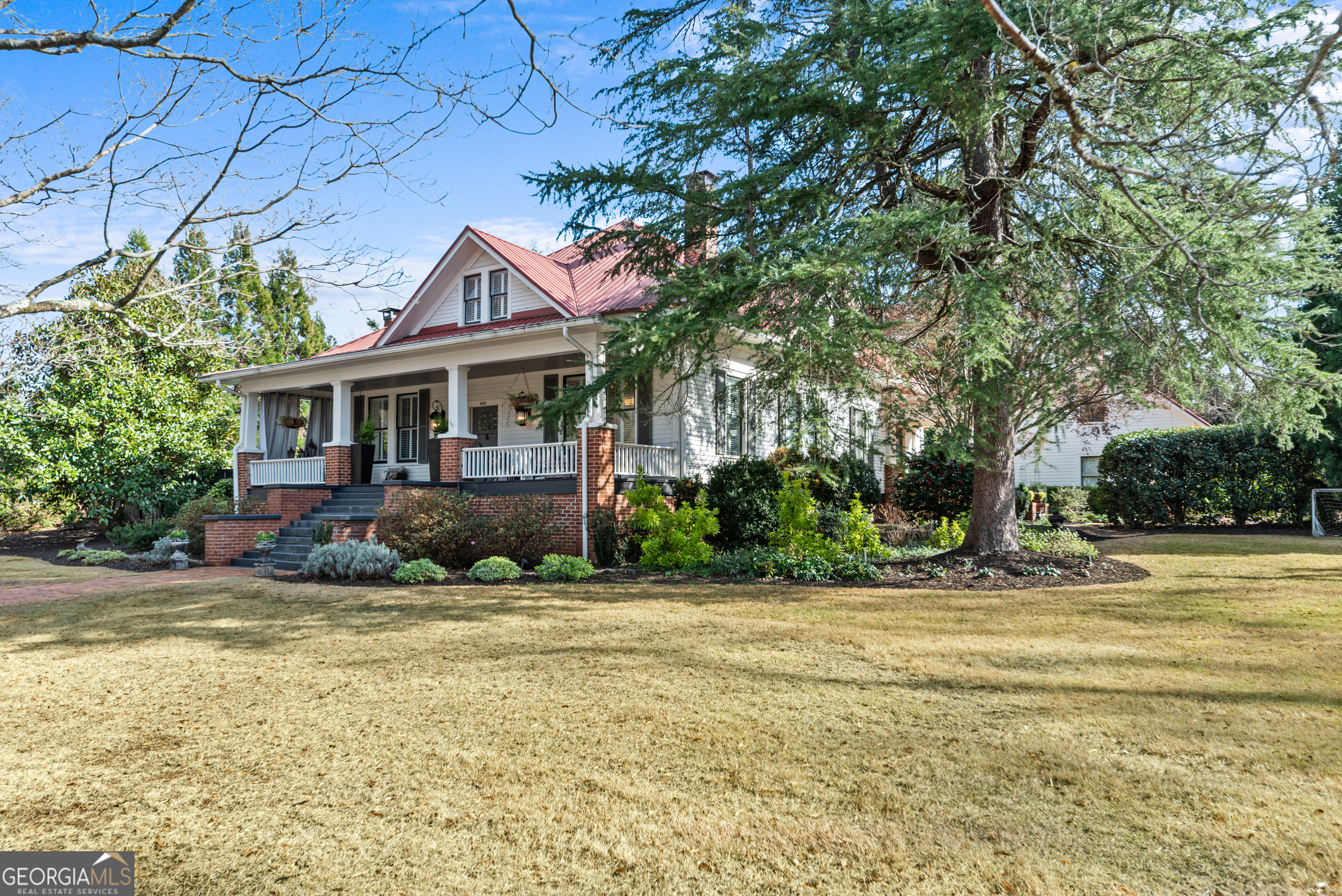 668 North Main Street Madison, GA 30650 - Photo 80 of 88 a front view of a house with a garden and tree