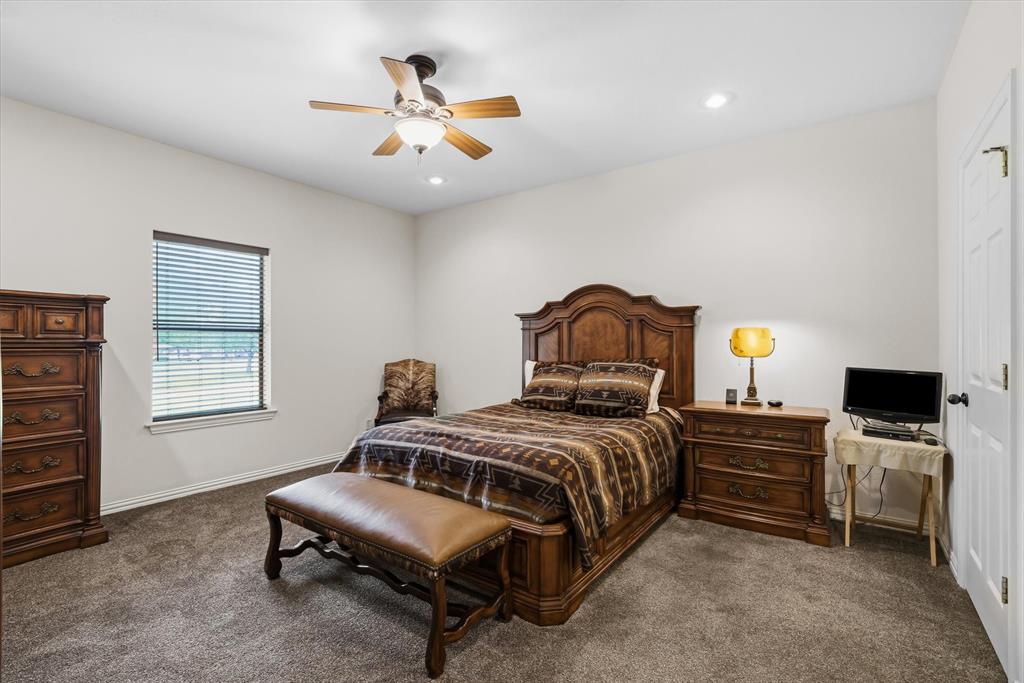 167 County Road 4202 Canton, TX 75103 - Photo 17 of 40 a bedroom with a bed a chandelier and a window