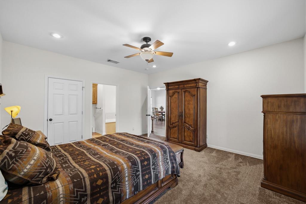 167 County Road 4202 Canton, TX 75103 - Photo 18 of 40 a bedroom with a bed and a chandelier