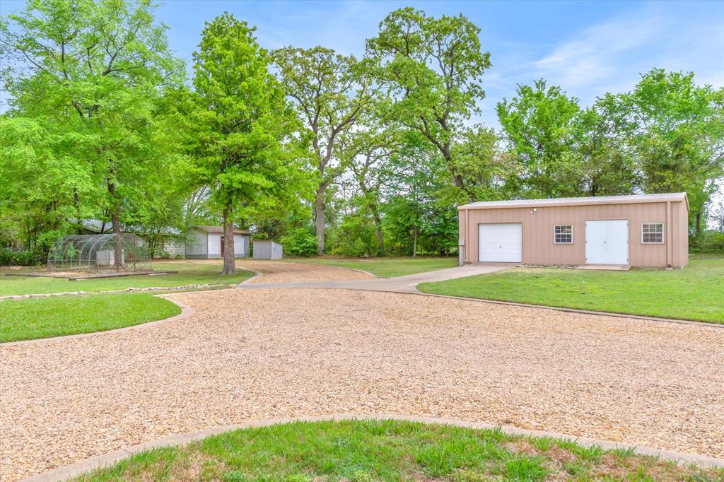 167 County Road 4202 Canton, TX 75103 - Photo 30 of 40 a view of a house with a yard and a large tree