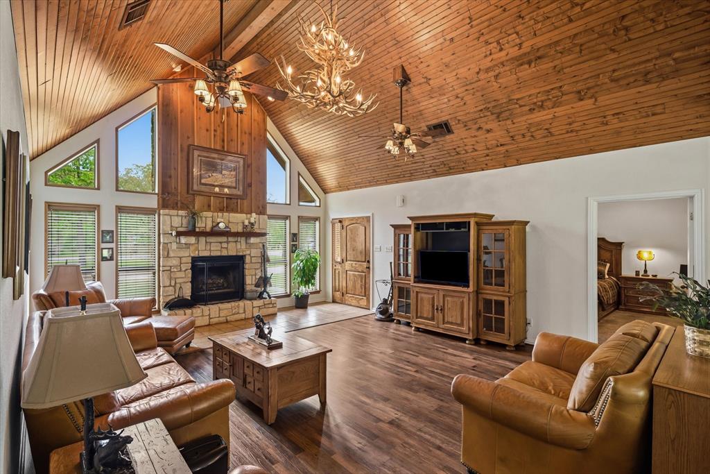167 County Road 4202 Canton, TX 75103 - Photo 9 of 40 a living room with furniture a flat screen tv and a fireplace