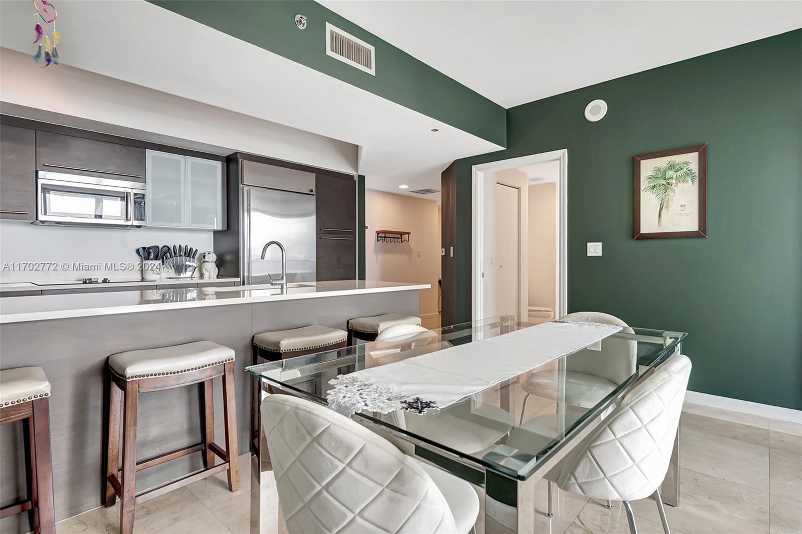 Brickell Miami, FL 33131 - Photo 17 of 52 a kitchen with a table chairs sink and cabinets