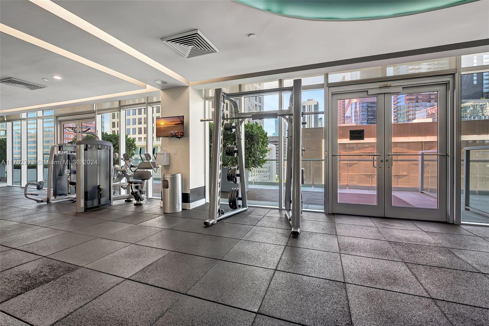 Brickell Miami, FL 33131 - Photo 33 of 52 a view of a room with gym equipment and large windows