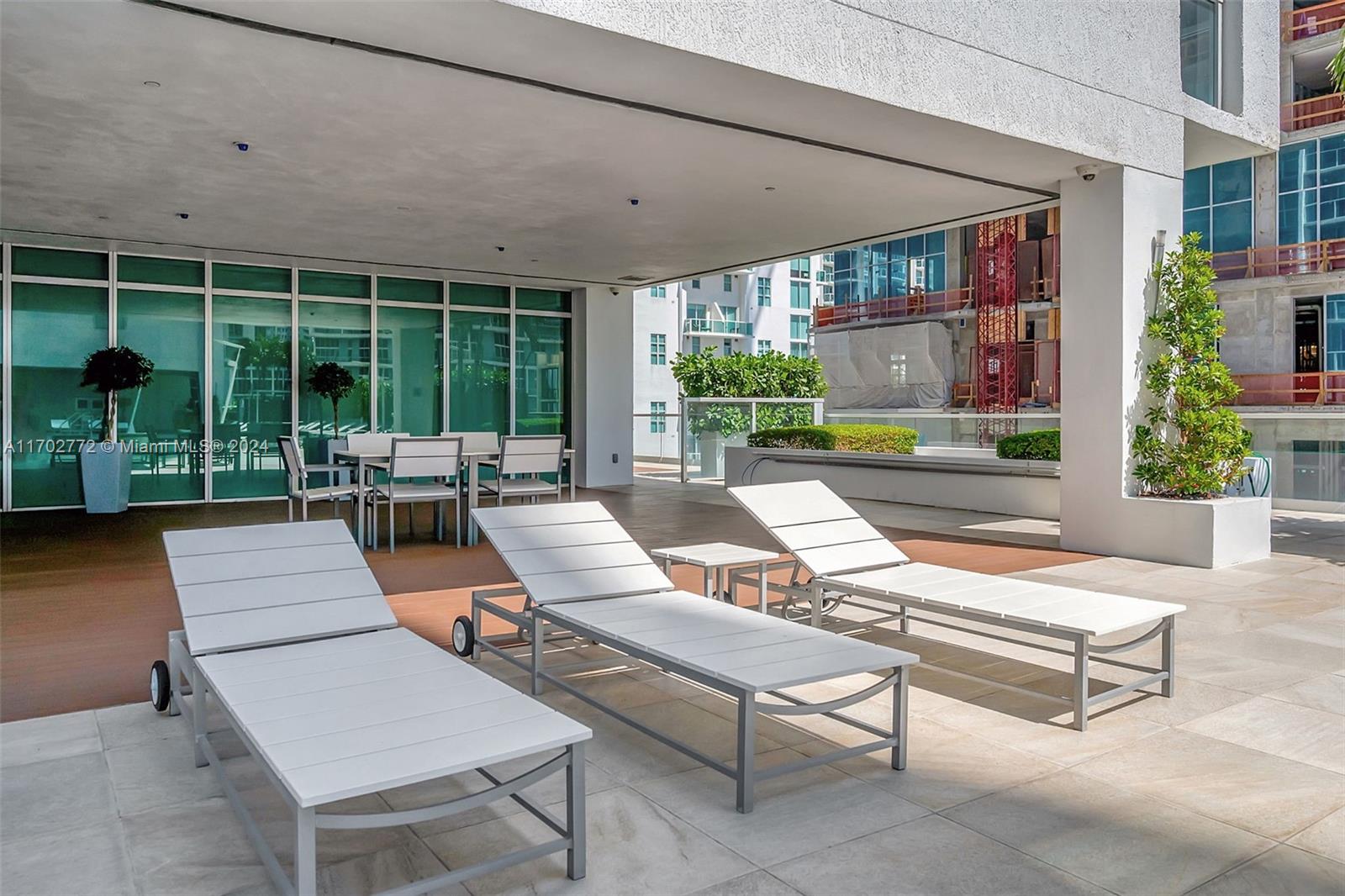 Brickell Miami, FL 33131 - Photo 38 of 52 a outdoor space with patio the couches and a dining table with garden view