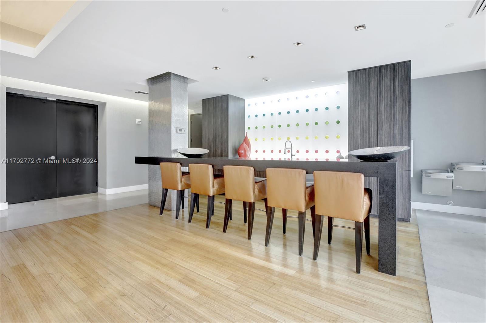 Brickell Miami, FL 33131 - Photo 43 of 52 a dining hall with stainless steel appliances kitchen island granite countertop a table chairs and a refrigerator