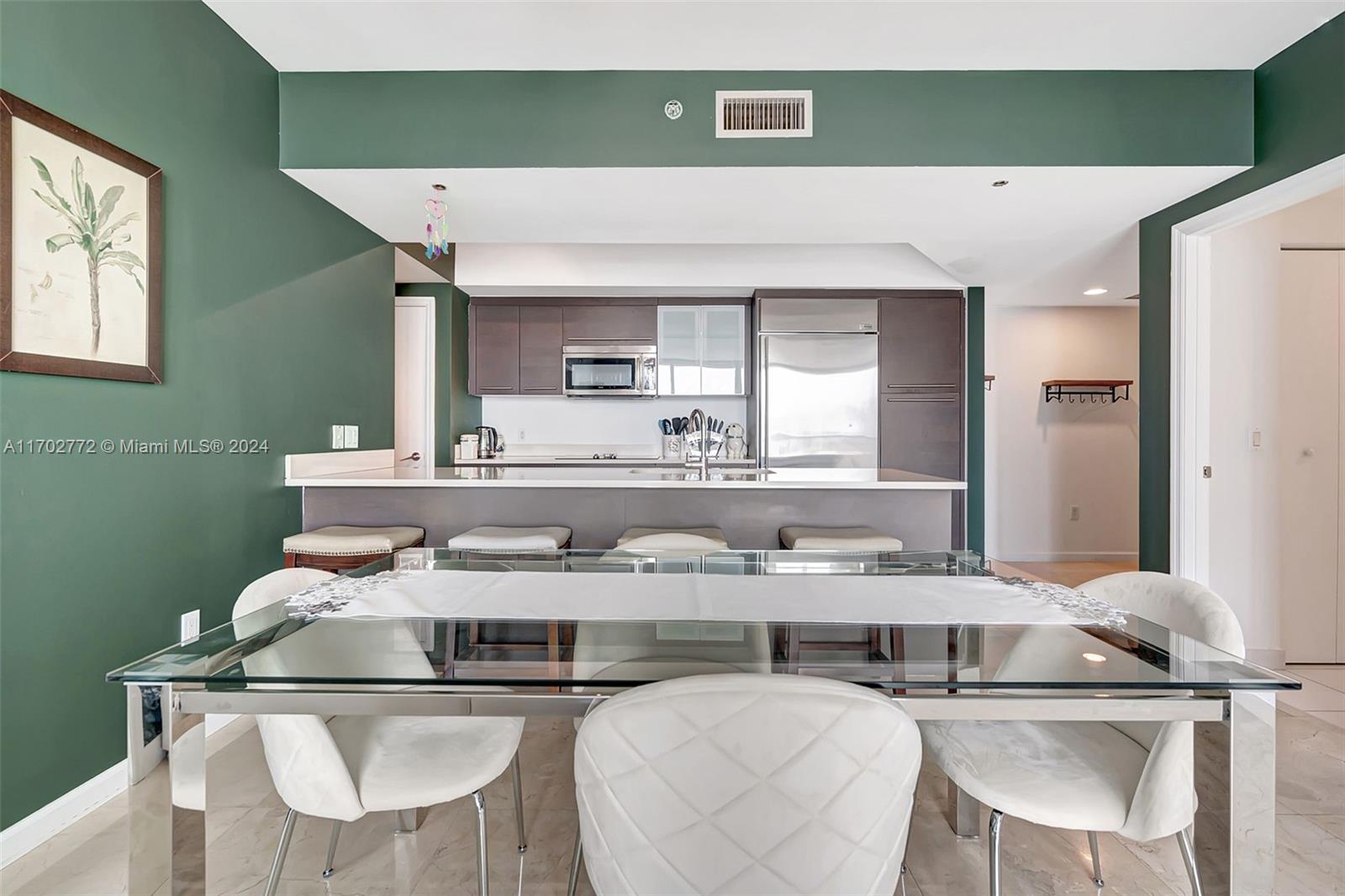 Brickell Miami, FL 33131 - Photo 6 of 52 a kitchen with stainless steel appliances granite countertop a sink and a refrigerator