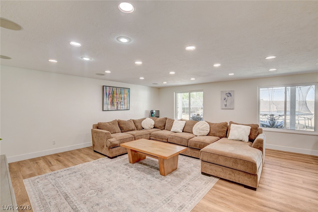 4362 Thistle Street Logandale, NV 89021 - Photo 48 of 99 Recessed lighting illuminates this inviting living space, featuring ample natural light through expansive windows.